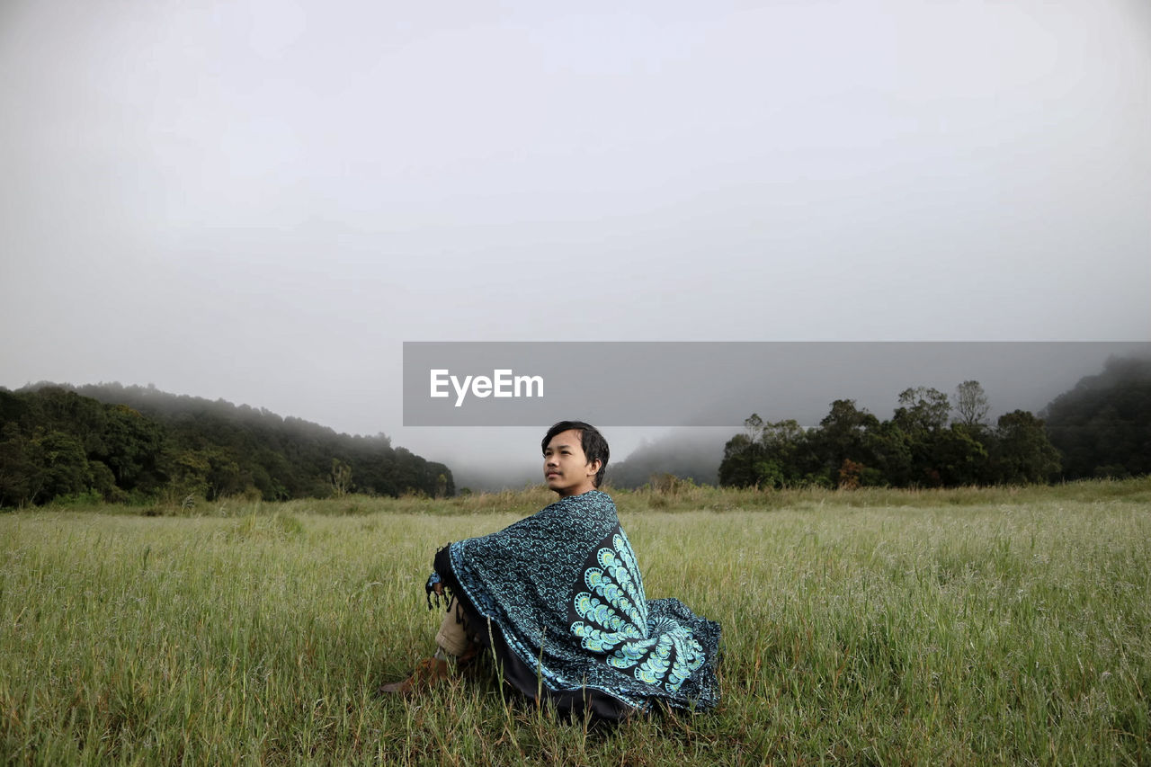 Man sitting on field