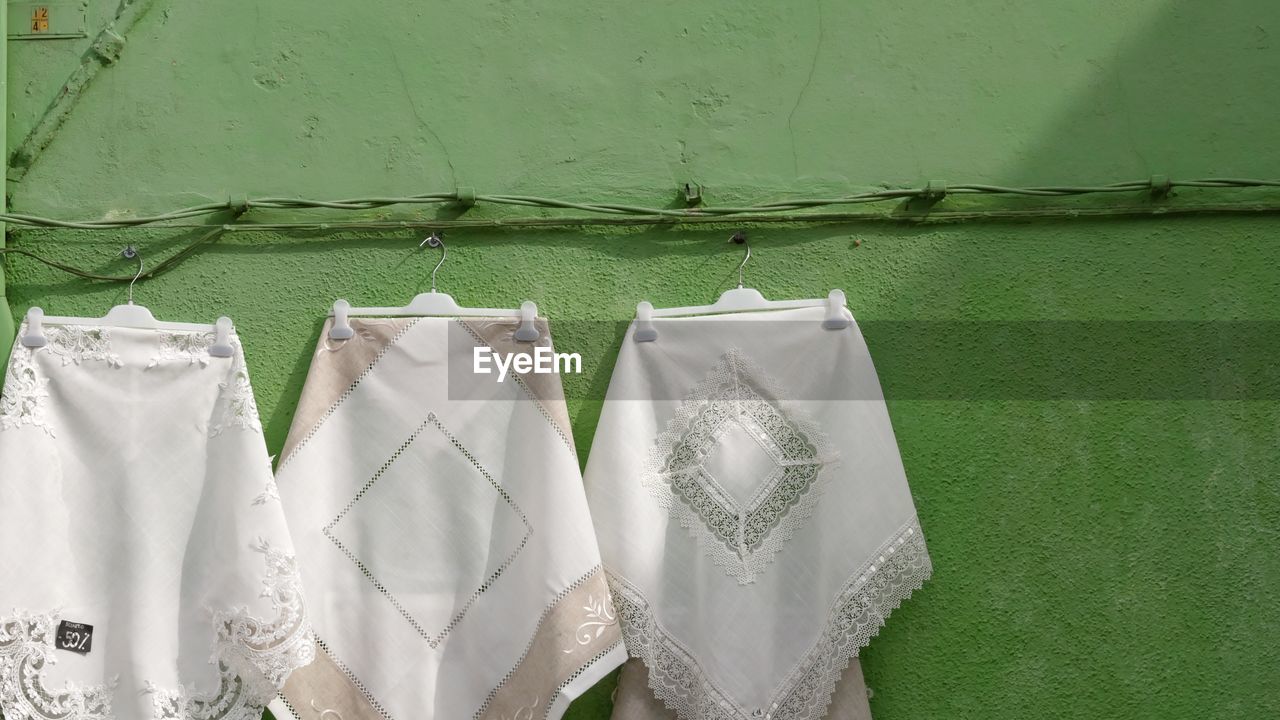 Close-up of clothes drying against wall