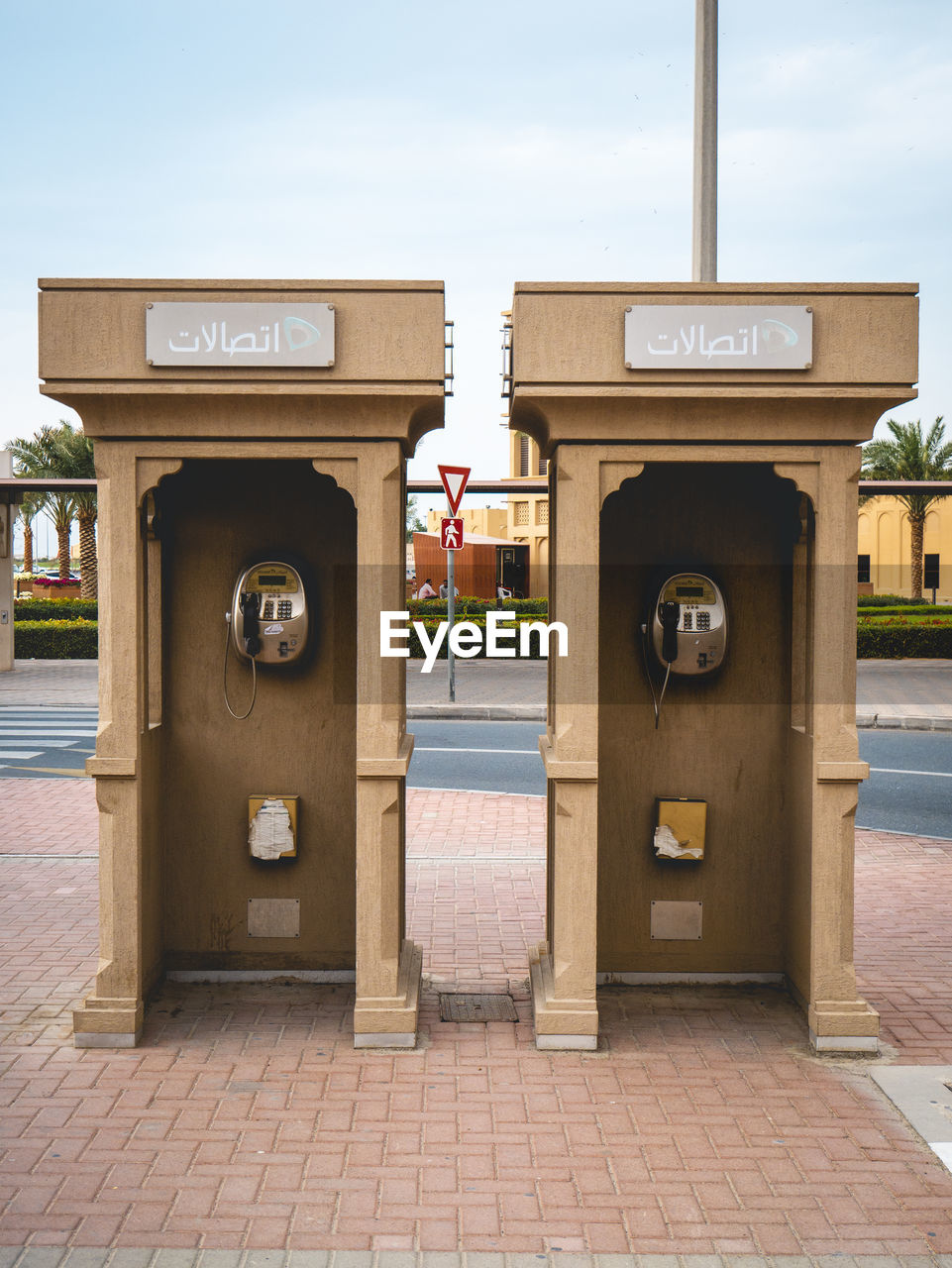 Two telephone booth against sky in city