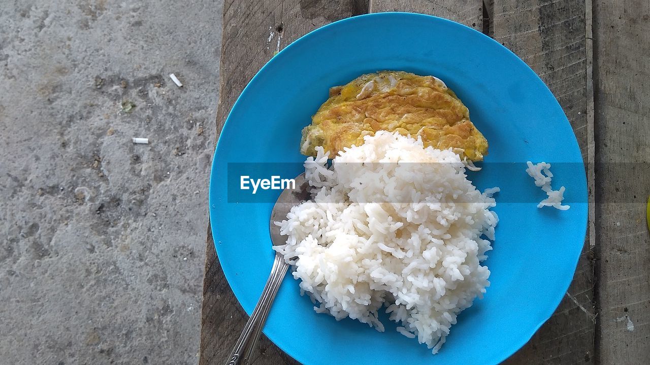 Directly above shot of rice and fried egg in plate on table