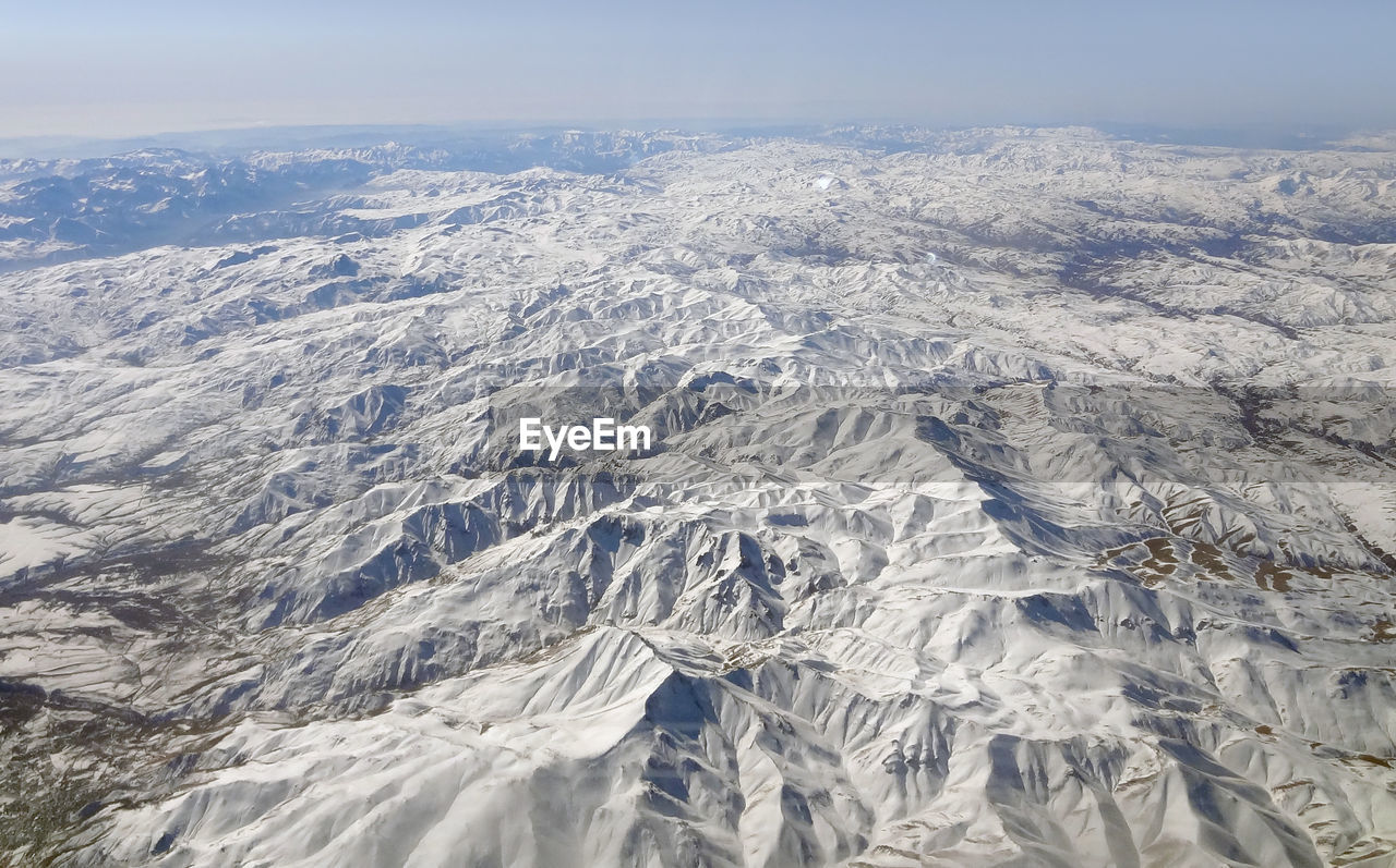 AERIAL VIEW OF SNOWCAPPED MOUNTAINS