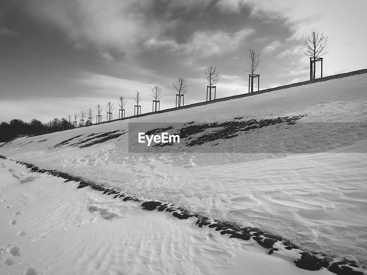 Snow covered land against sky