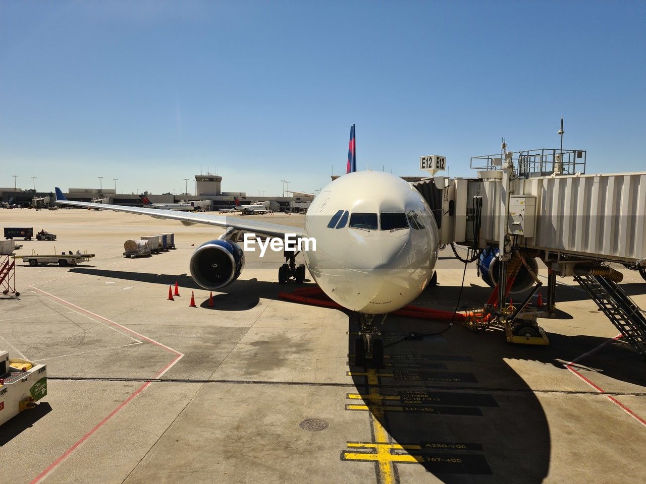 Airplane on airport runway against clear sky