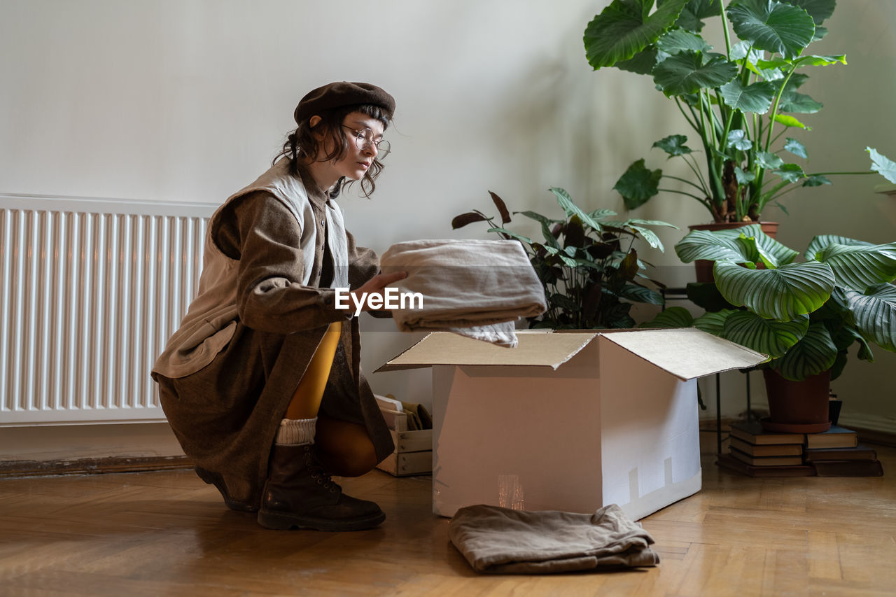 side view of mother and daughter sitting on table