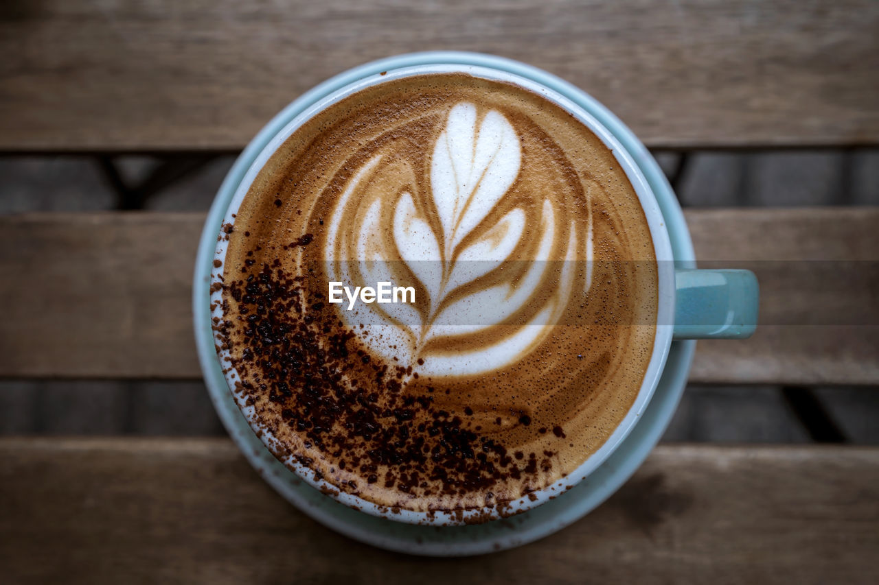 coffee, drink, food and drink, cup, refreshment, coffee cup, mug, frothy drink, hot drink, cappuccino, froth art, latte, still life, wood, table, food, freshness, crockery, indoors, close-up, creativity, no people, brown, saucer, directly above, coffee milk, high angle view, flat white, cafe, dairy, milk, kitchen utensil