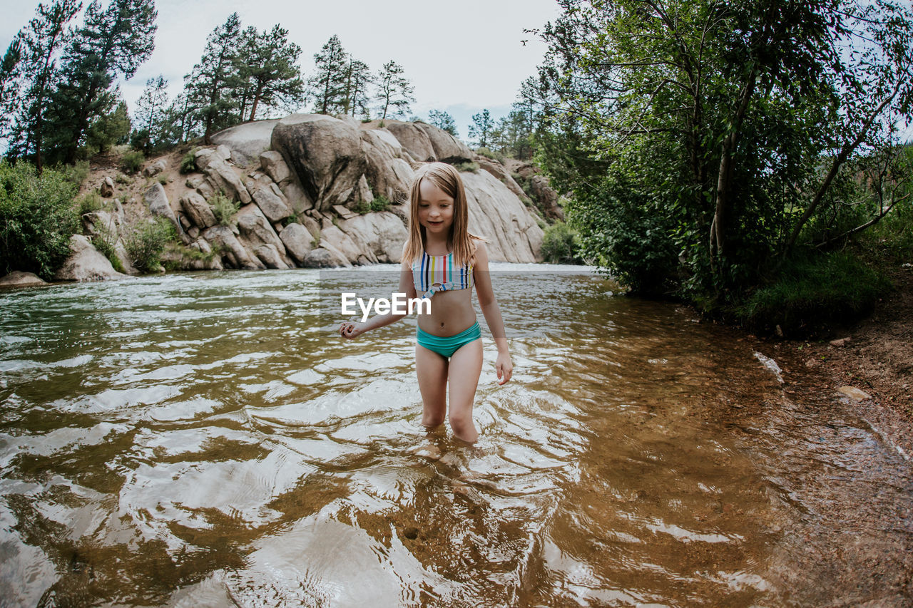 Young girl playing on the banks of the platte river