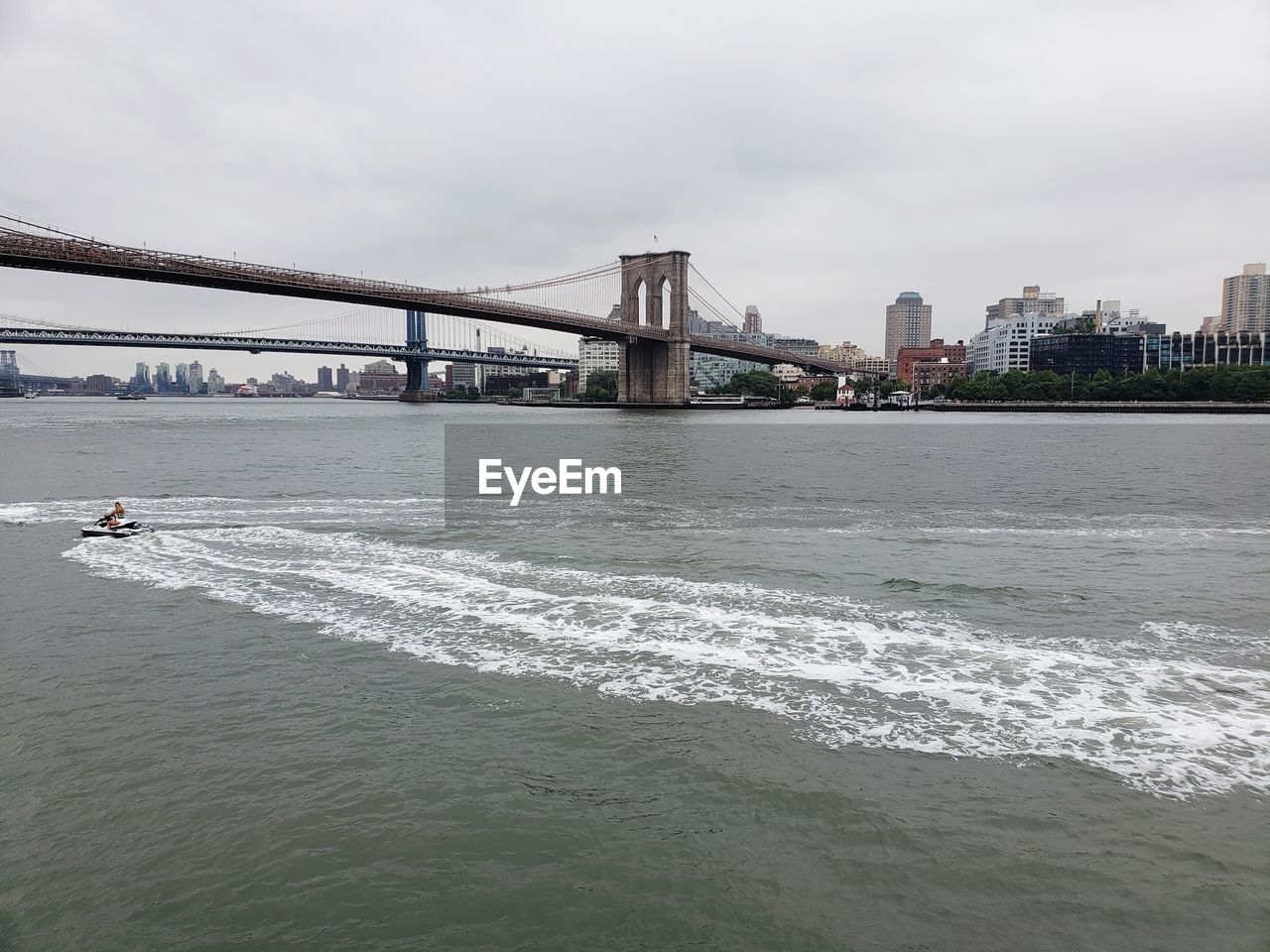 View of bridge over sea against cloudy sky