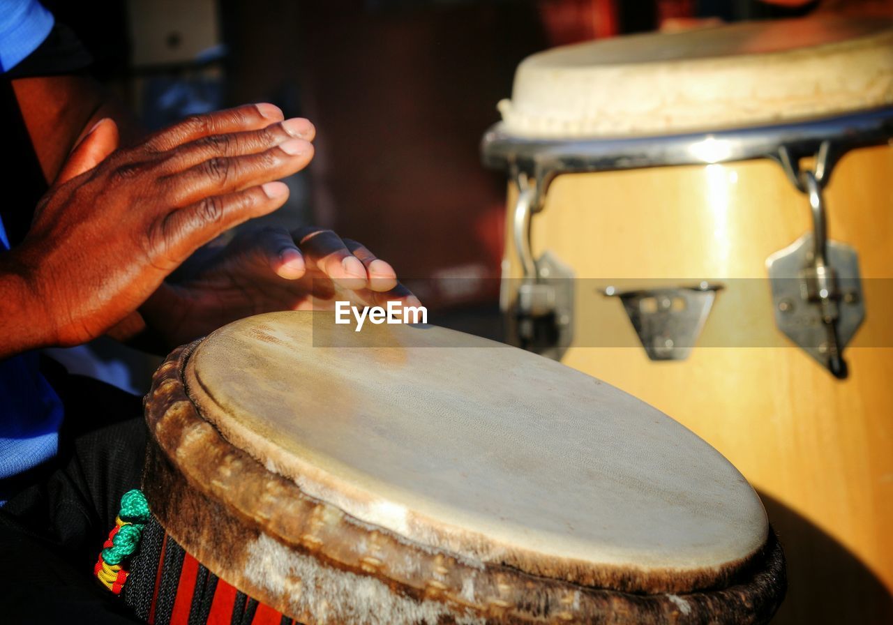 Detail shot of hands playing the drum