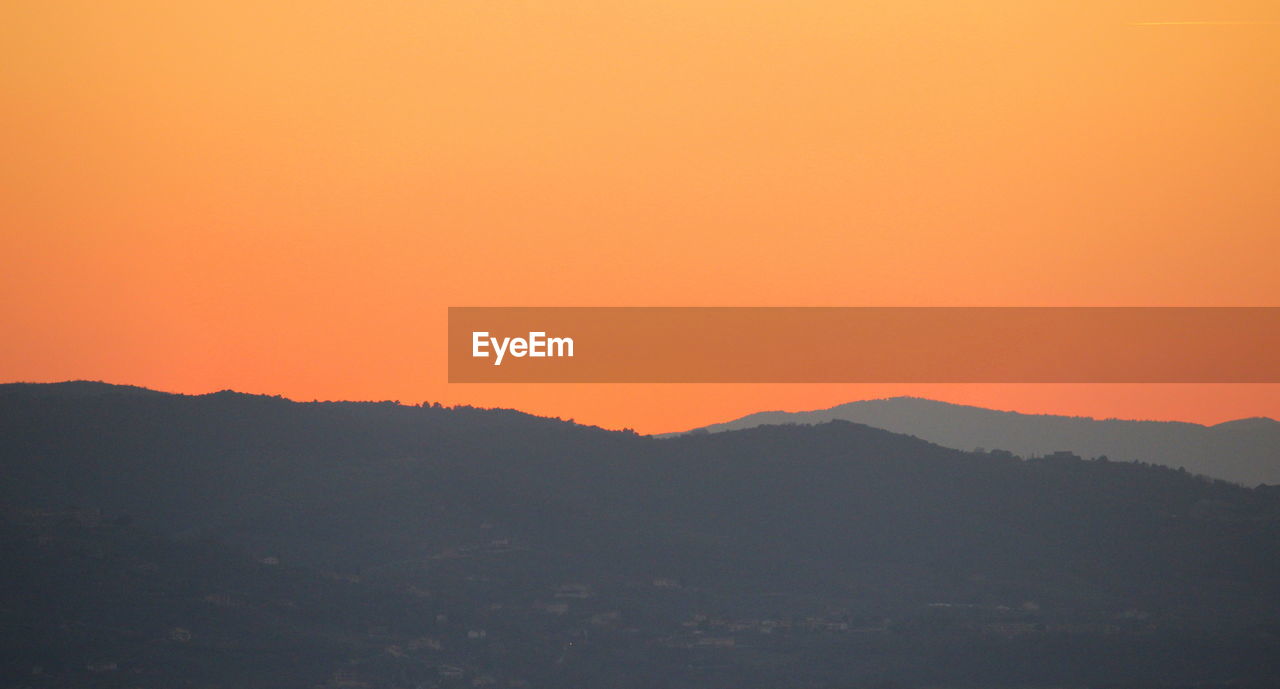 Scenic view of mountains at sunset