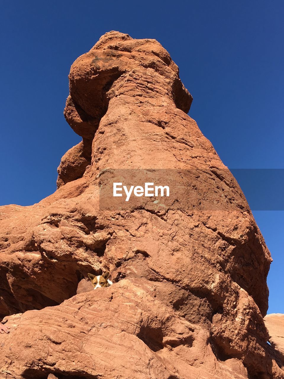 LOW ANGLE VIEW OF ROCK FORMATIONS AGAINST BLUE SKY