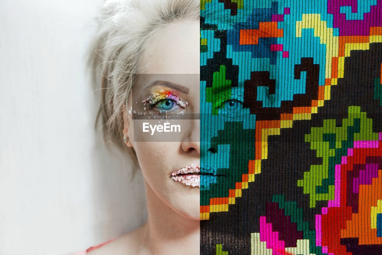 Digital composite image of woman with make-up and colorful pattern against wall