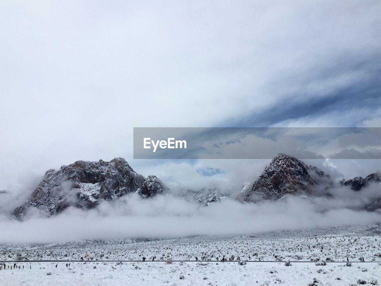 Snow covered field against sky