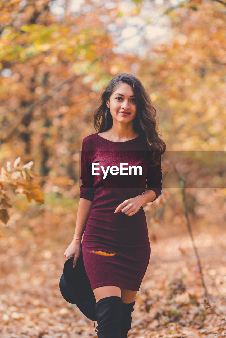 Portrait of young woman in autumn leaves