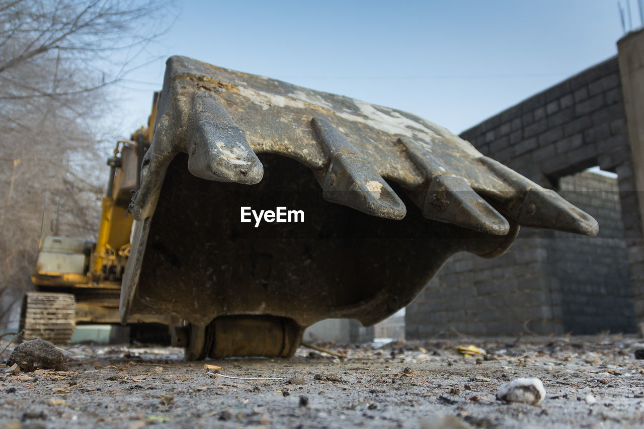 Abandoned excavator on the field against a clear sky