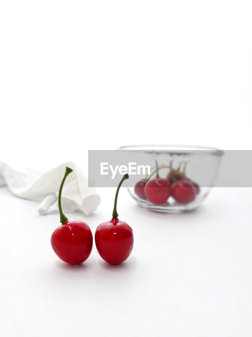 CLOSE-UP OF TOMATOES ON GLASS TABLE