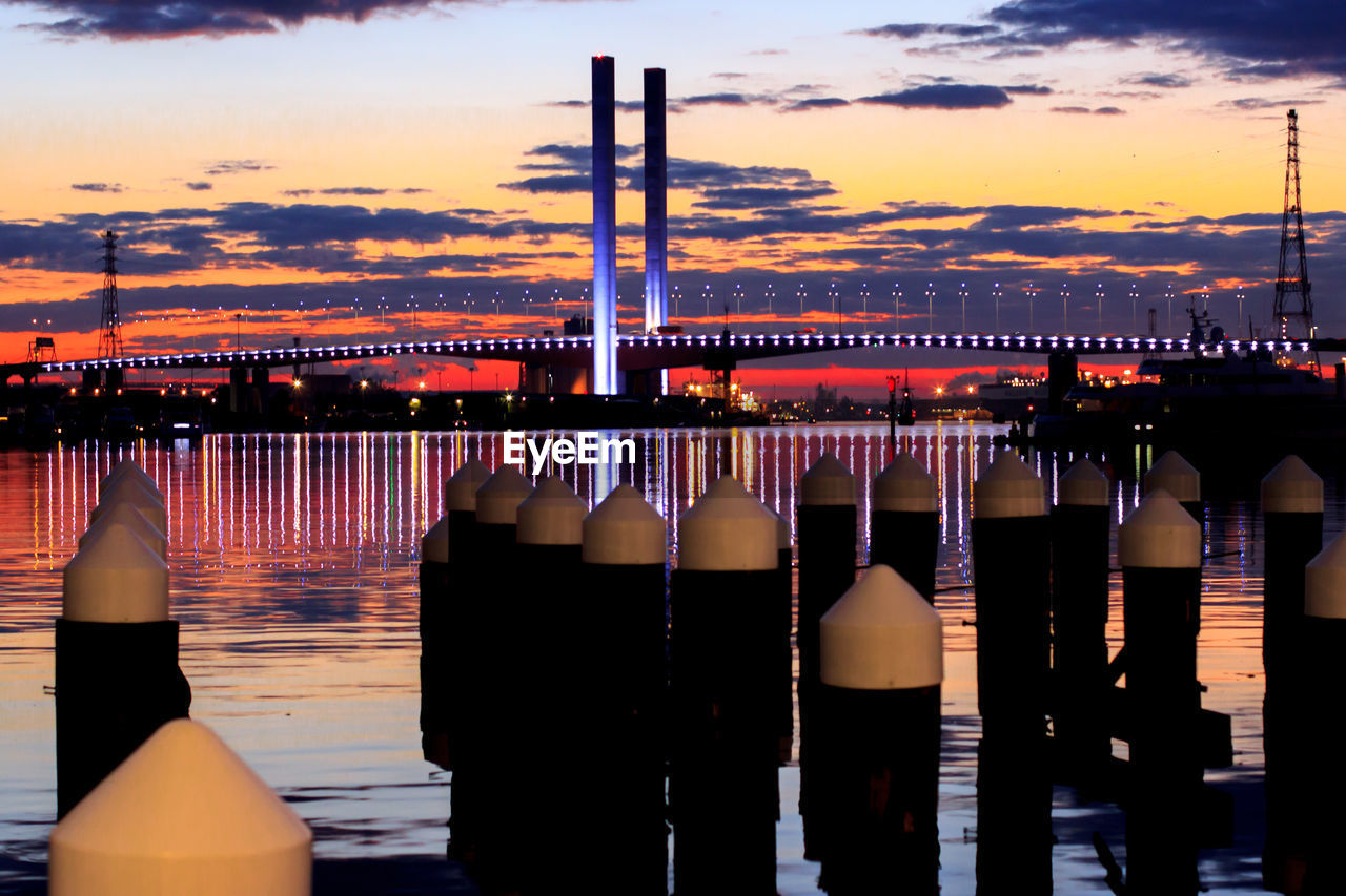 Illuminated westgate bridge against dramatic sky during sunset