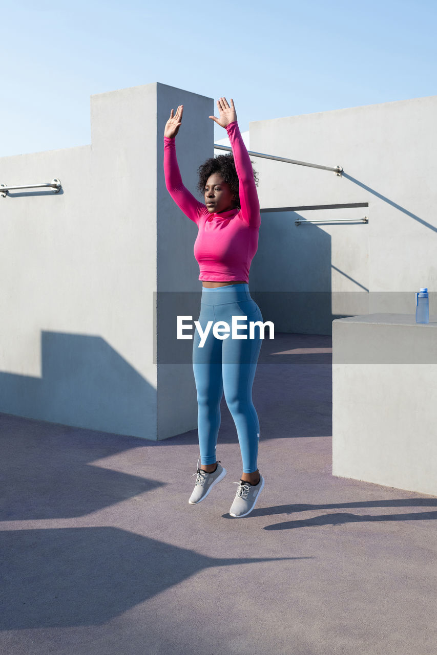 African american sportswoman doing burpee exercise