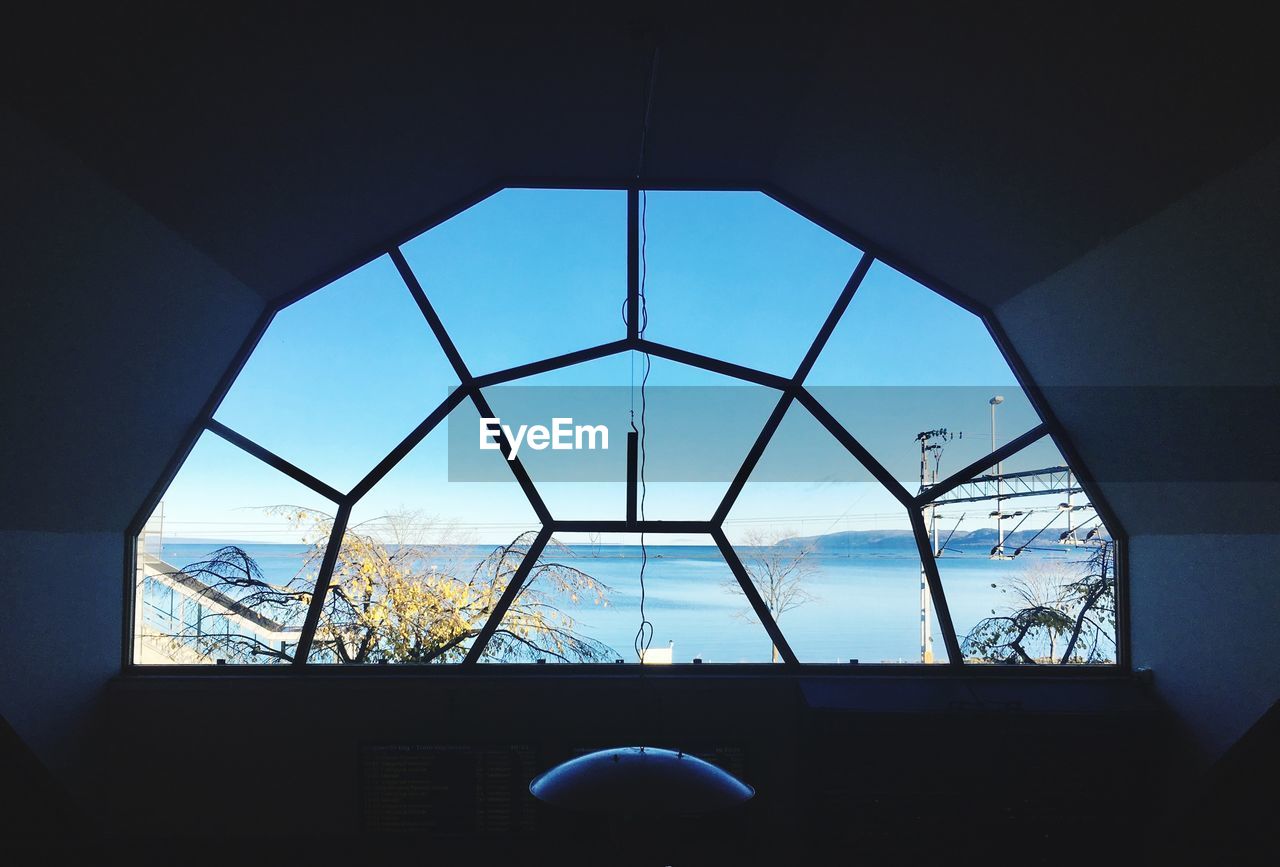 CLOSE-UP OF WINDOW AGAINST BLUE SKY SEEN THROUGH WINDOWS