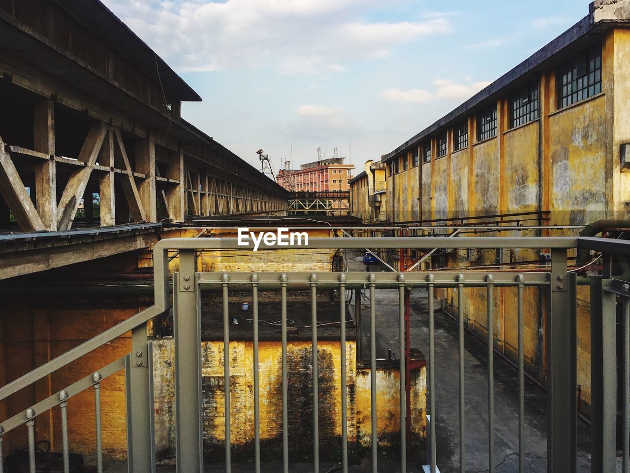 Train on bridge in city against sky