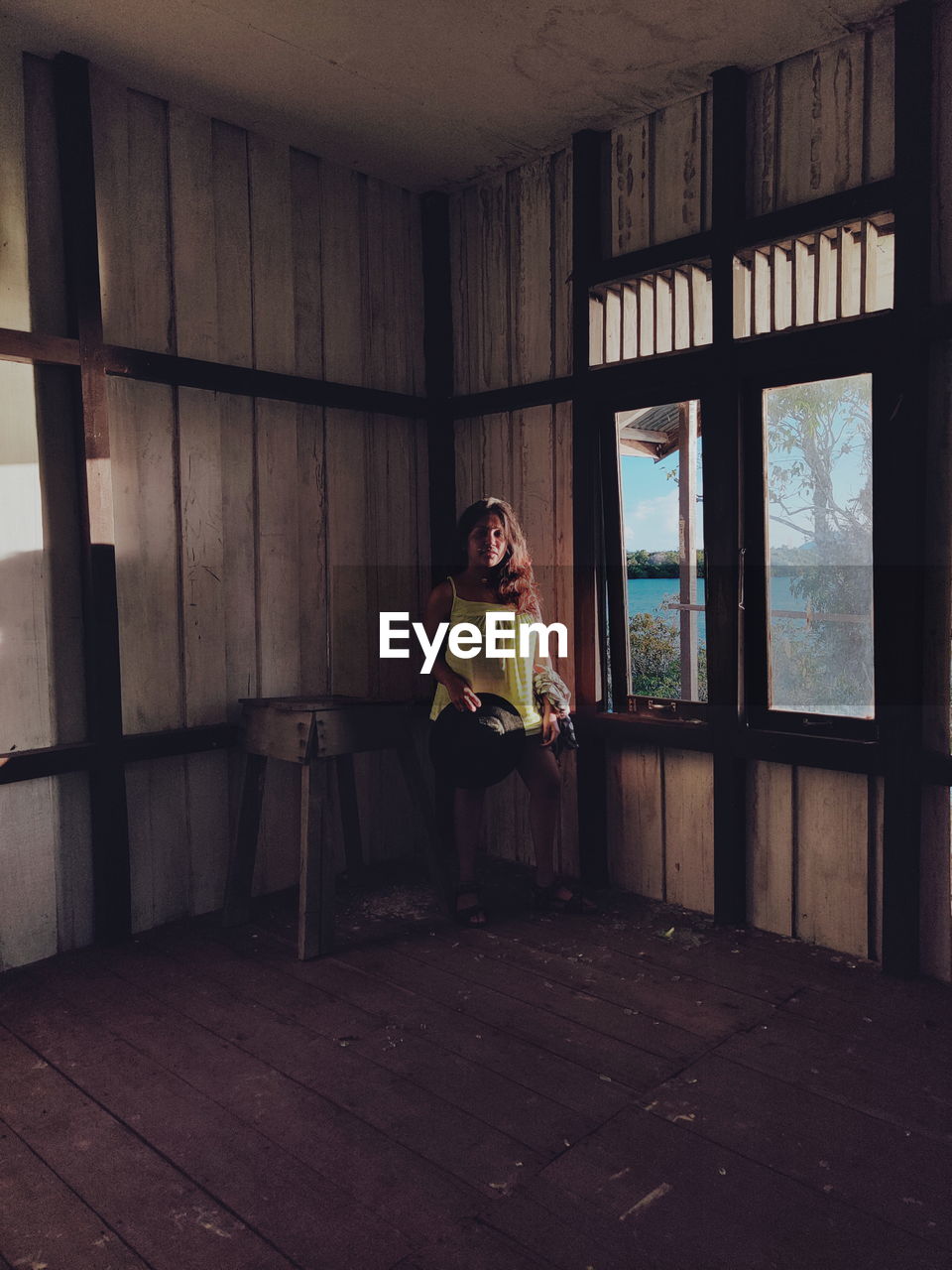 Woman sitting in abandoned house