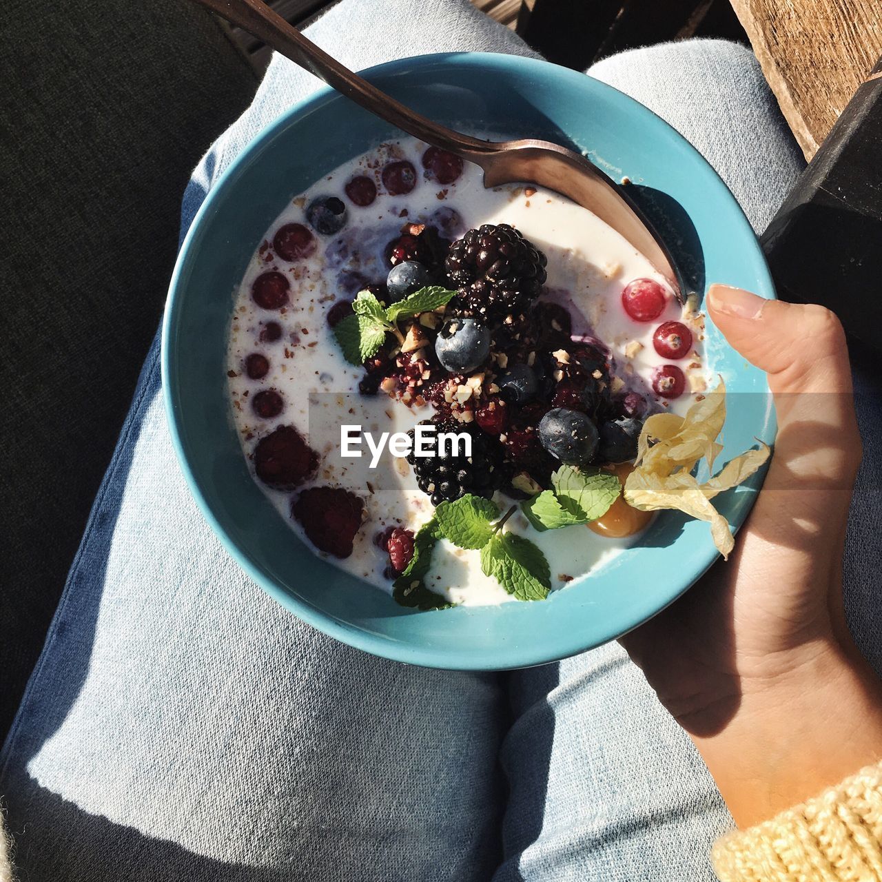 Midsection of woman holding porridge in bowl