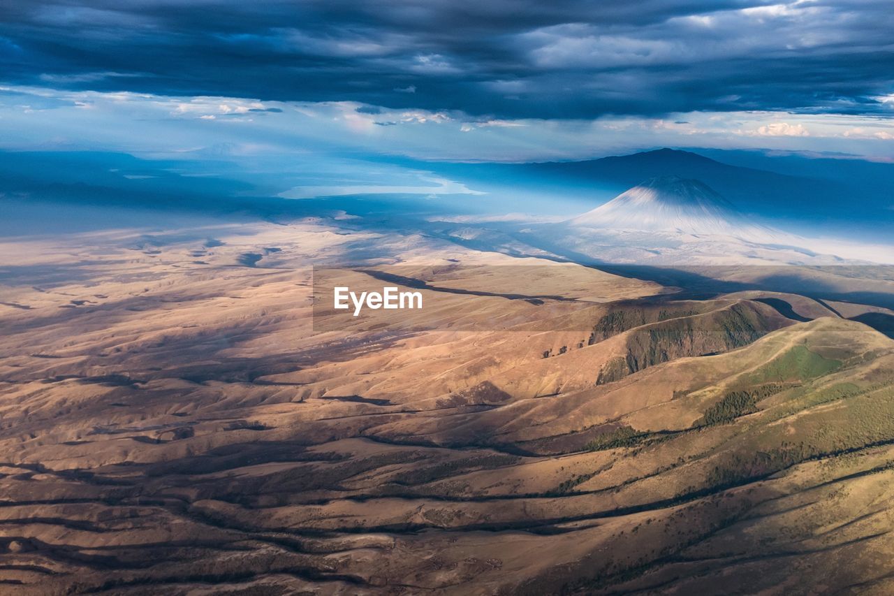 Scenic view of sand dunes against sky