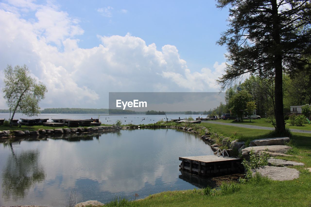 PANORAMIC VIEW OF RIVER BY TREES AGAINST SKY