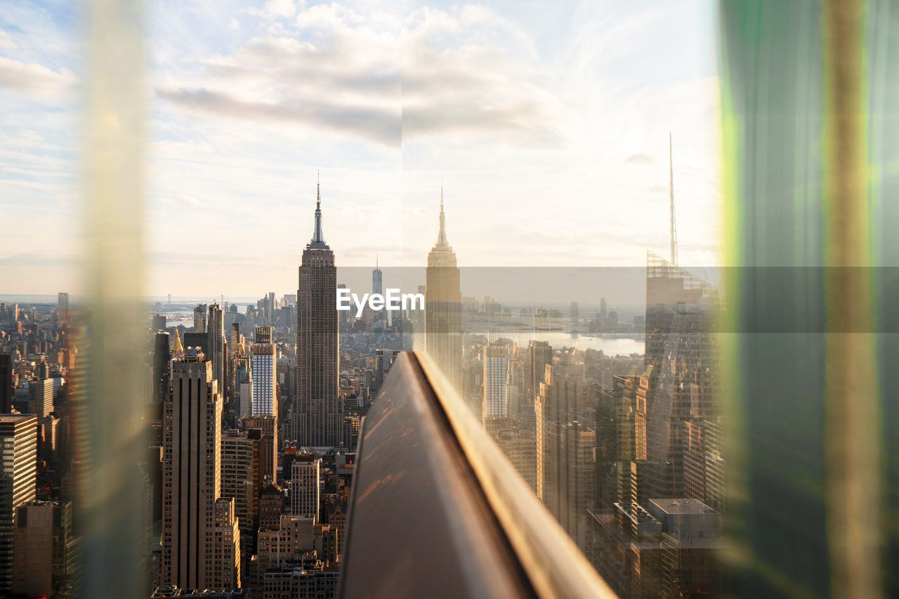 Usa, new york, new york city, midtown manhattan at sunset seen through window