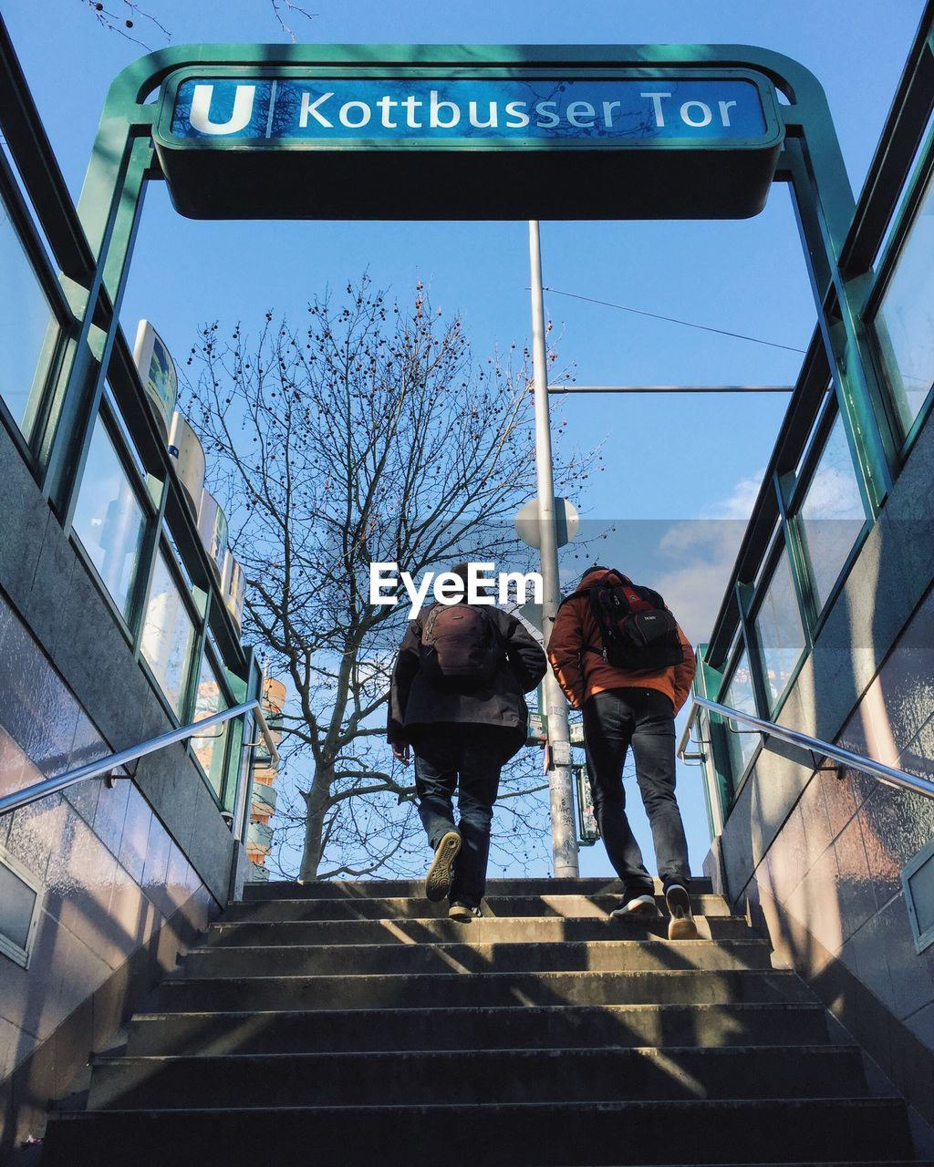 Low angle view of people moving up on staircase at subway station