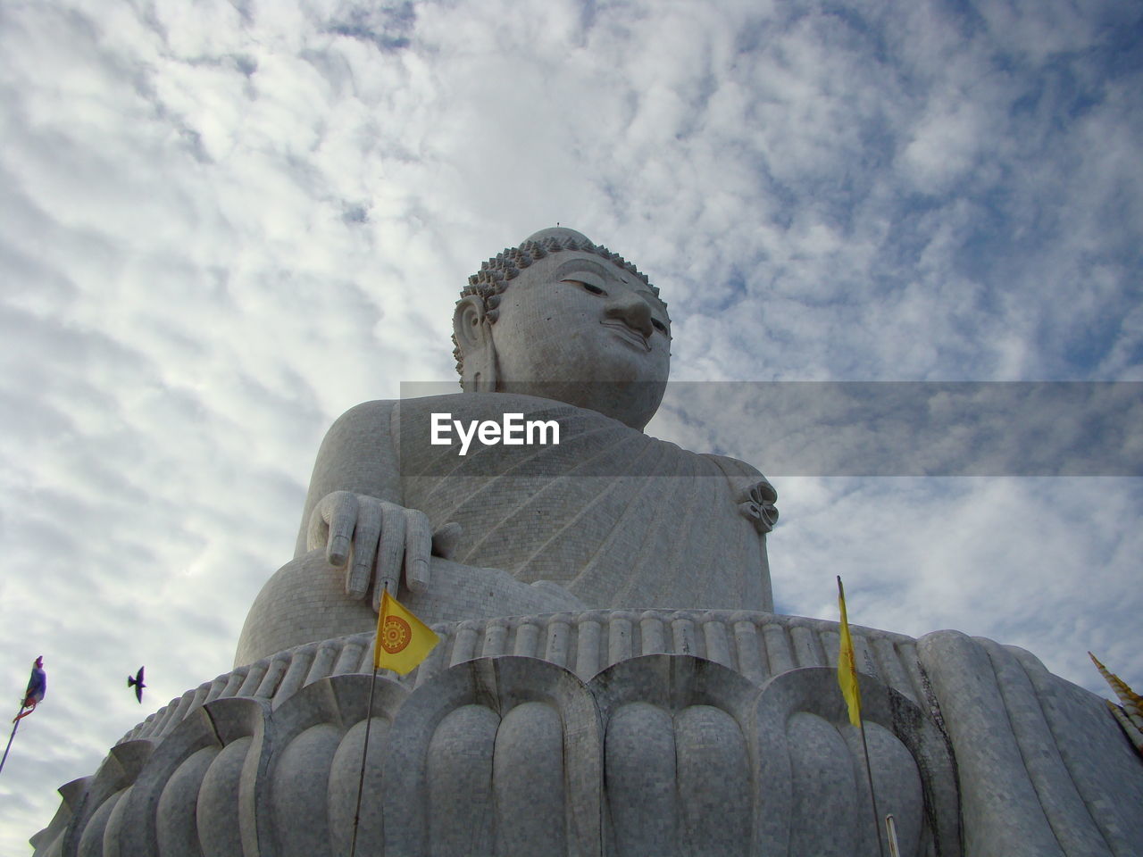 Thai big buddah against cloudy sky