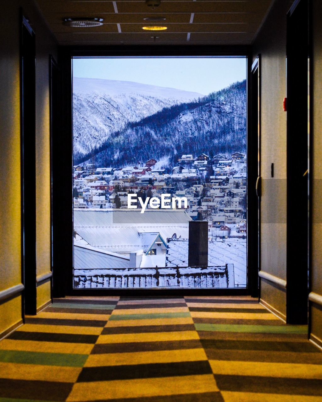 Scenic view of snowcapped mountains seen through window