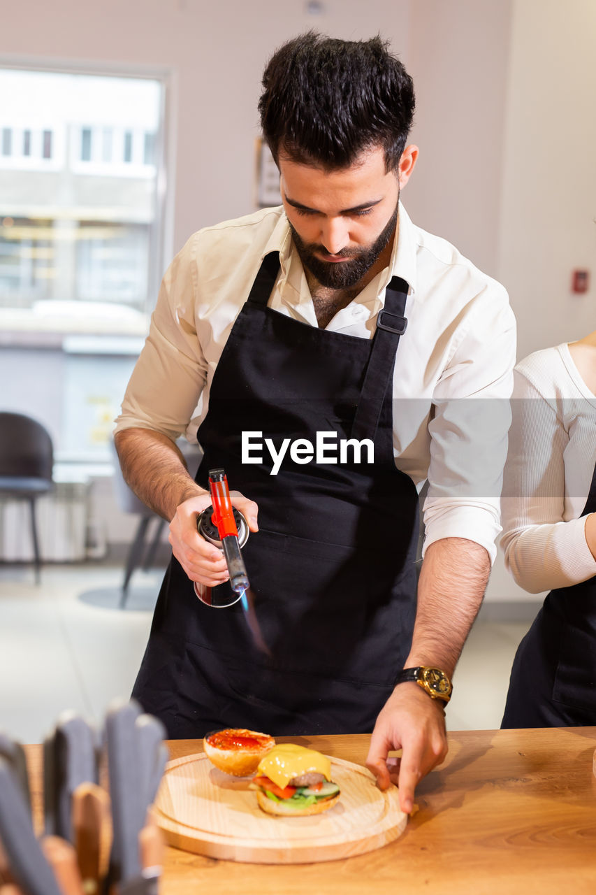 man preparing food at table