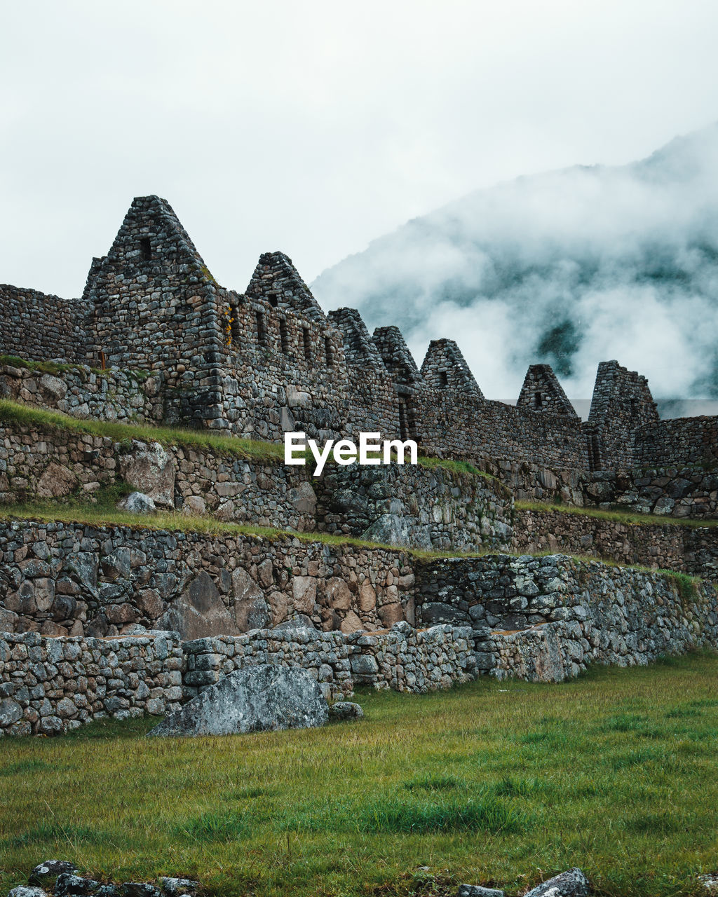 Low angle view of old ruin building against cloudy sky