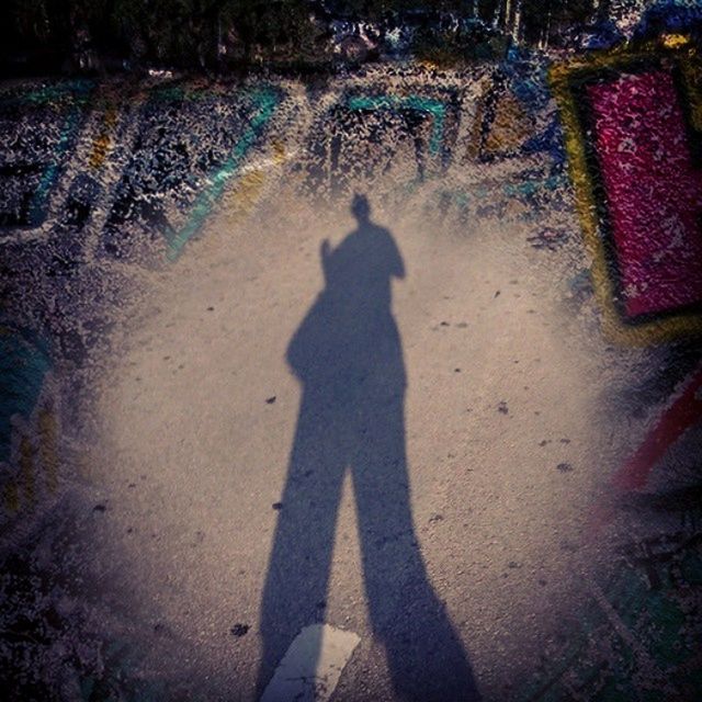 SHADOW OF PEOPLE STANDING ON GROUND