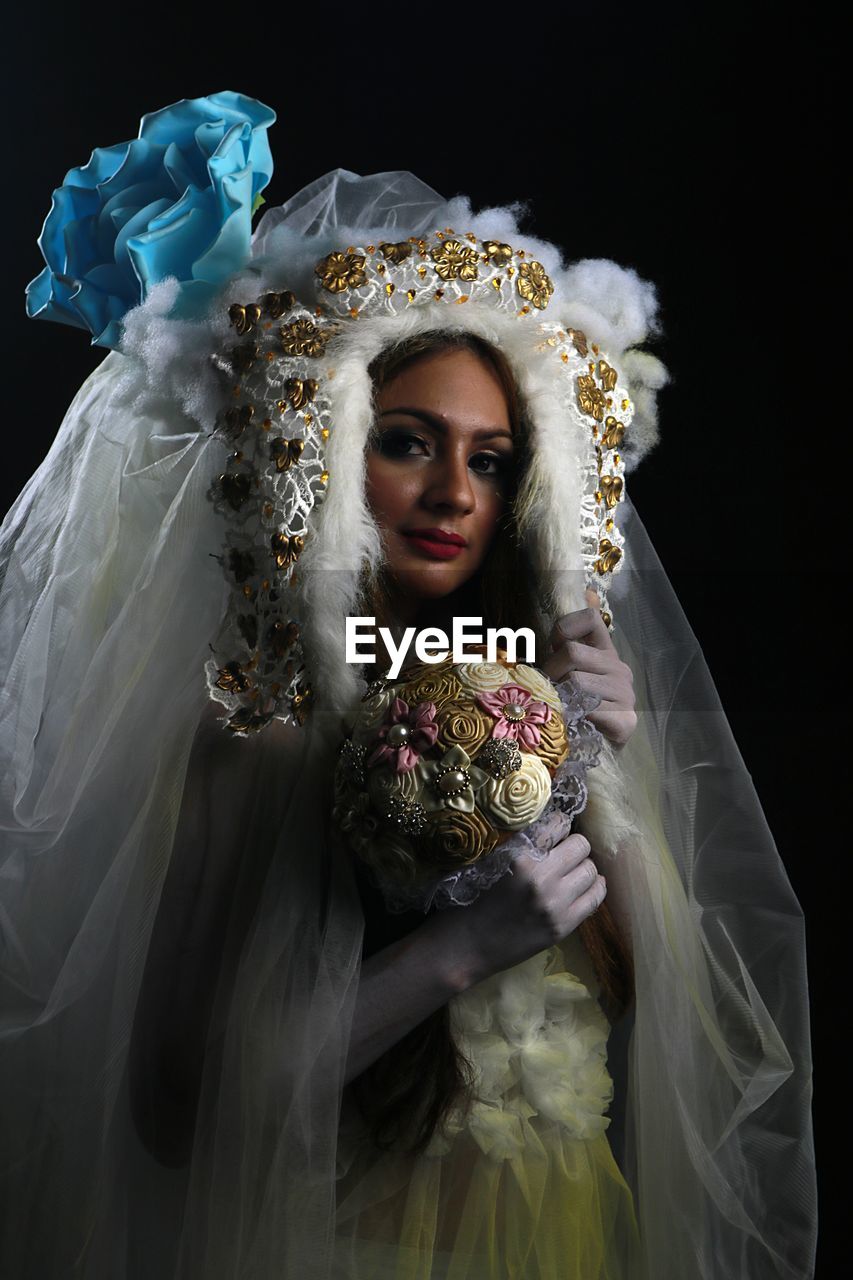 Portrait of young woman with bouquet