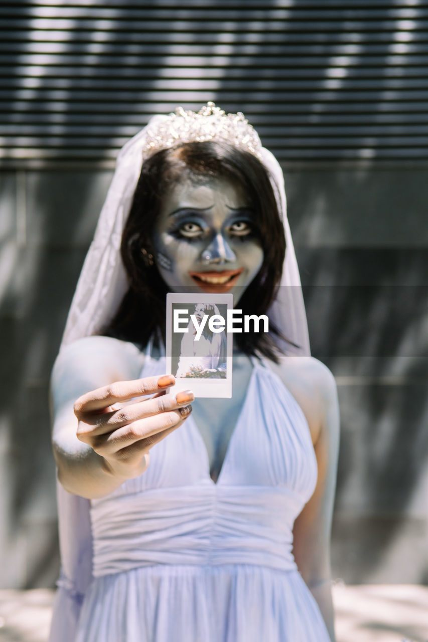 women, bride, adult, wedding dress, one person, young adult, portrait, celebration, clothing, female, religion, holding, fashion, looking at camera, event, dress, person, architecture, wedding, belief, emotion, spirituality, waist up, standing, white