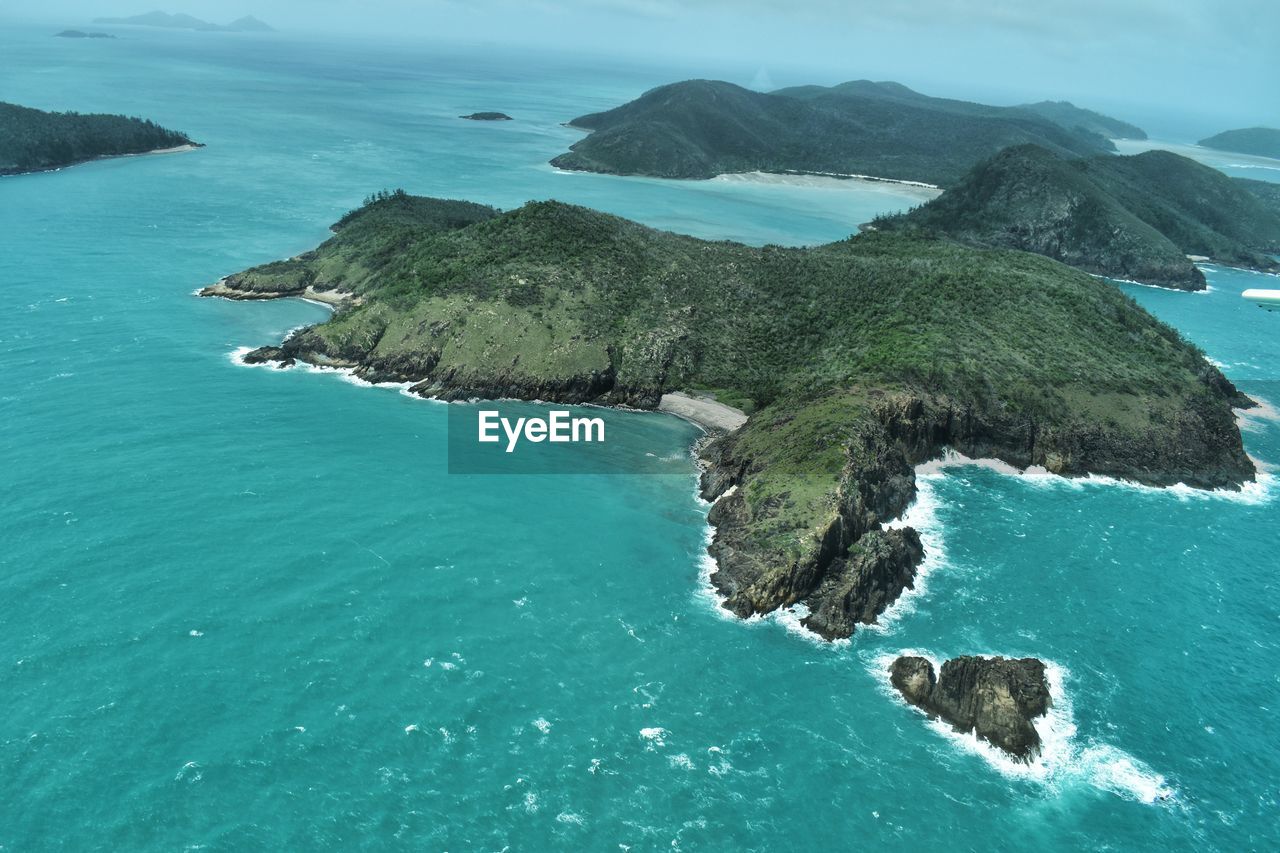 High angle view of rocks on sea against sky