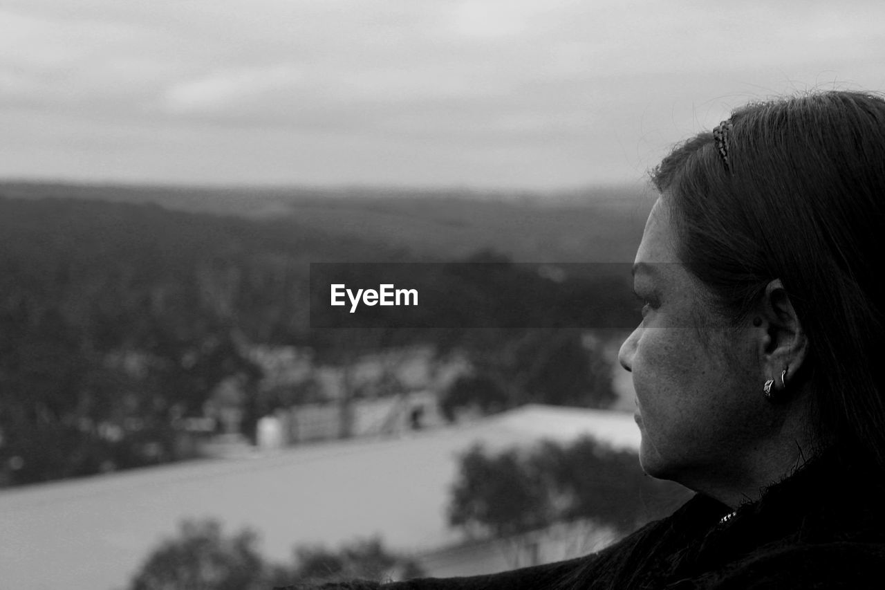 Side view of woman looking at mountain