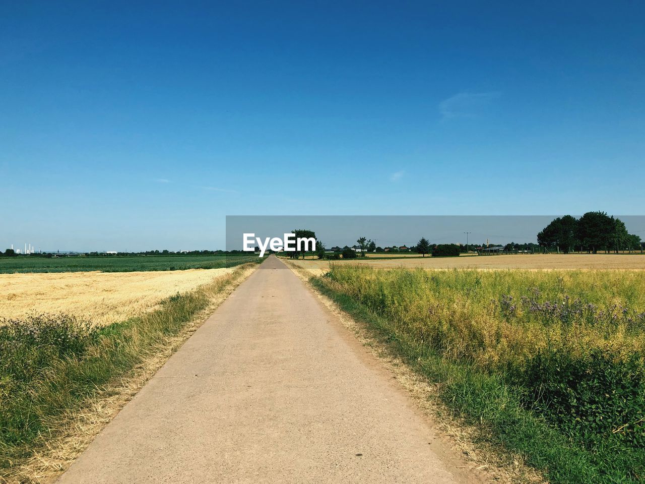 Empty road along countryside landscape