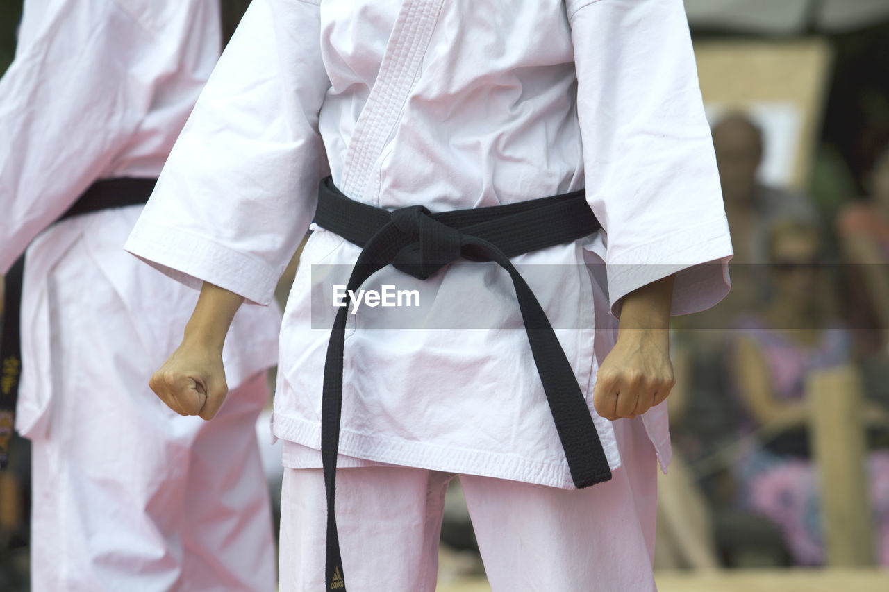 Midsection of women standing during karate