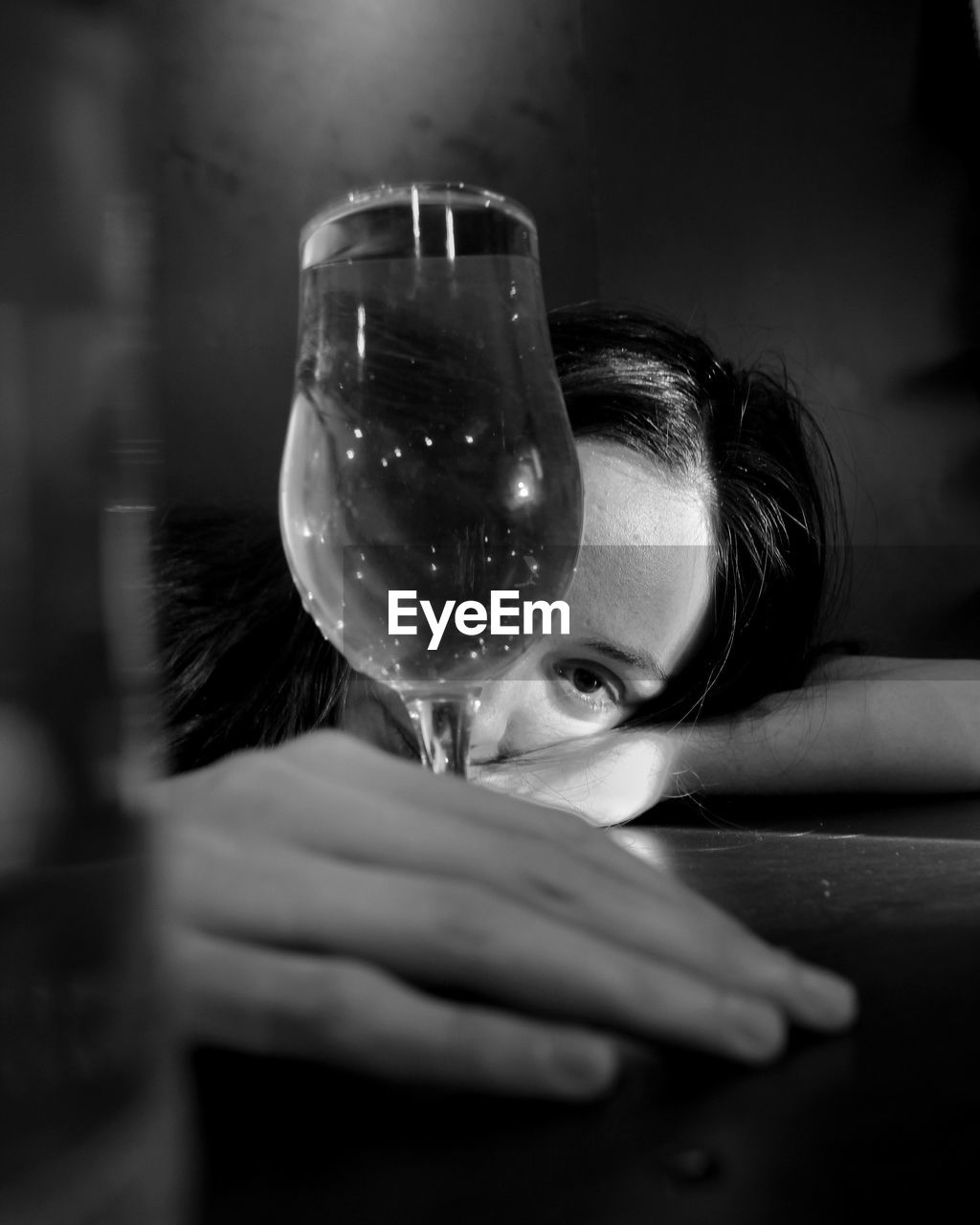 Portrait of woman drinking glass on table