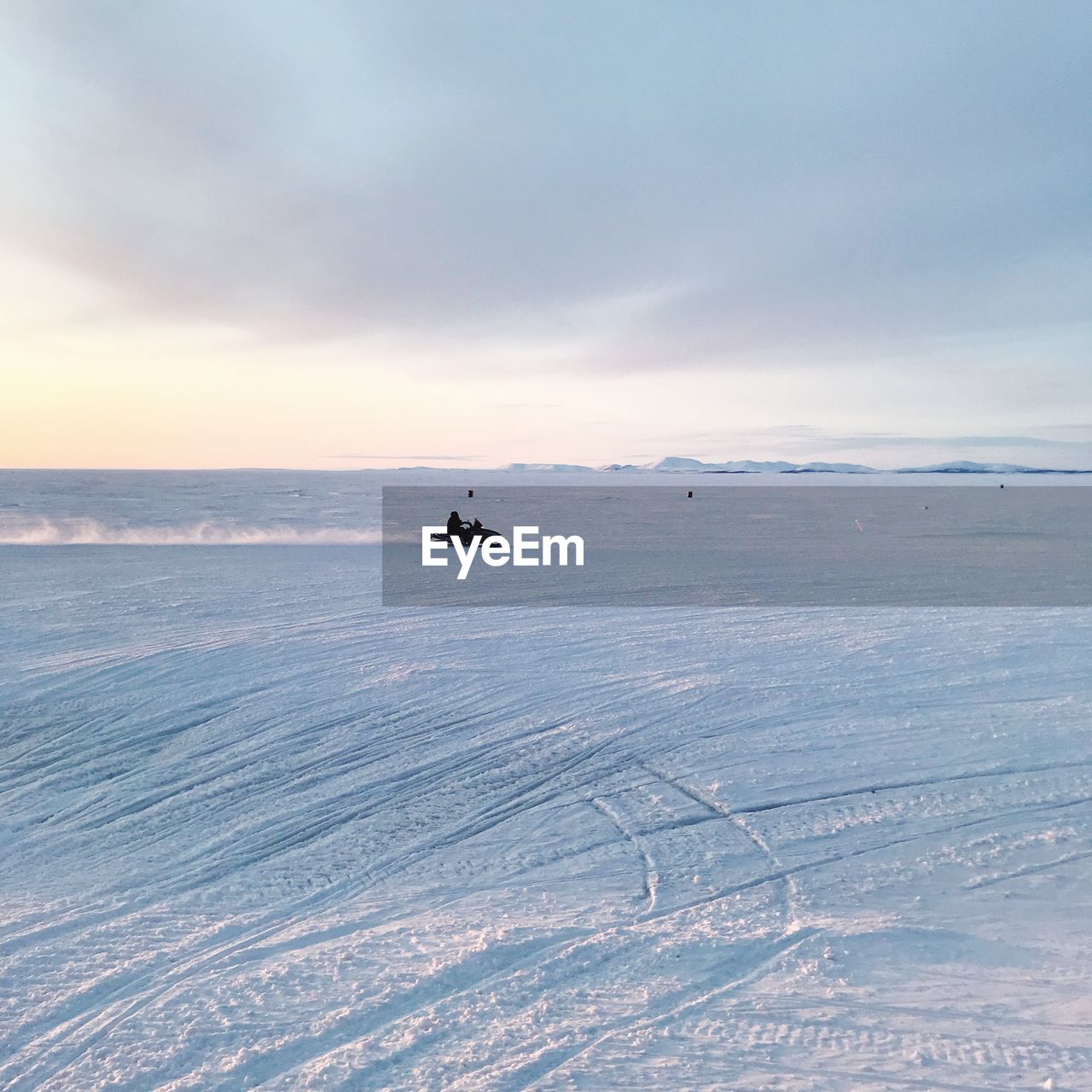 Man snowmobiling on snow covered landscape