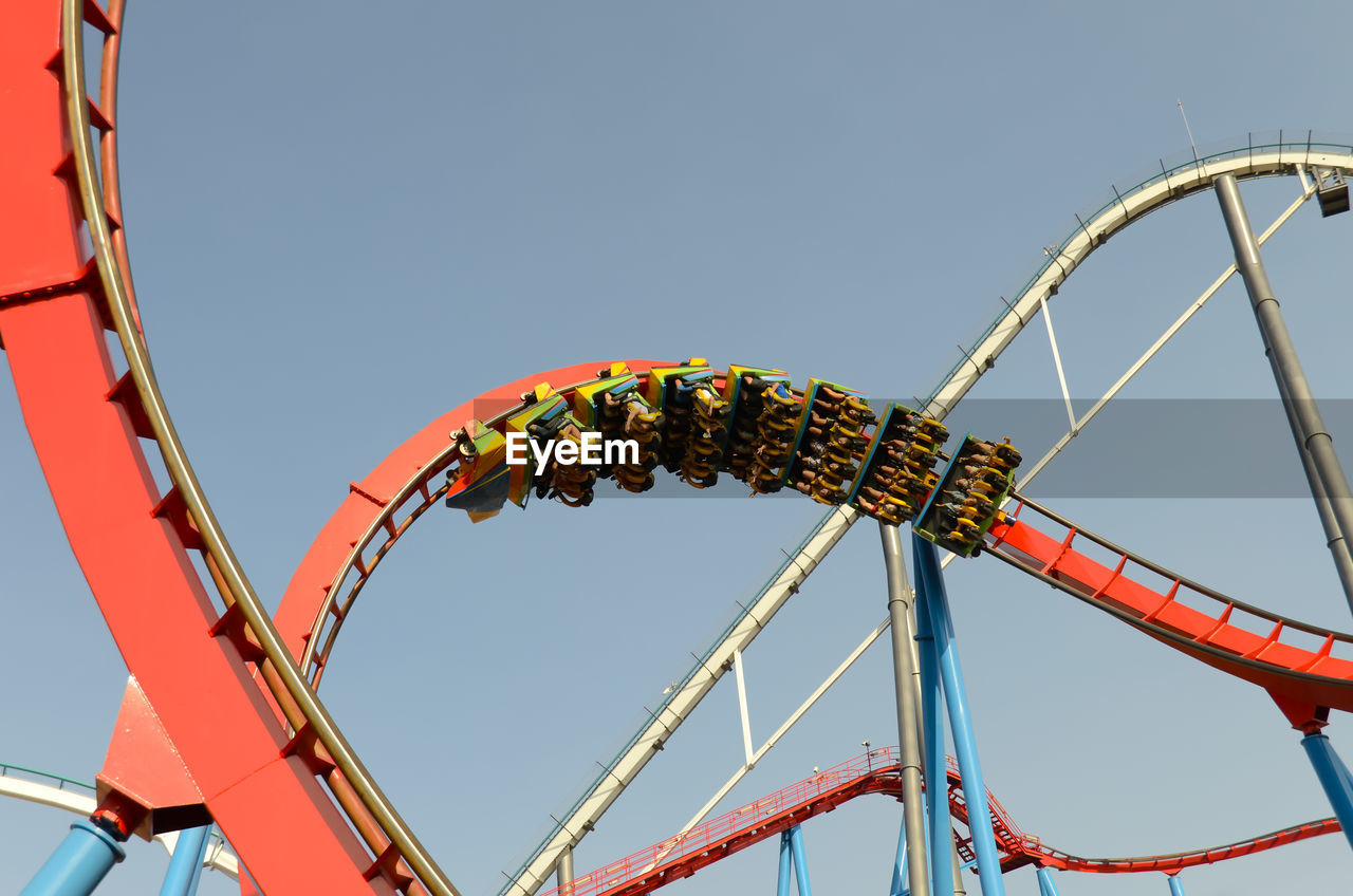 Low angle view of rollercoaster against clear sky