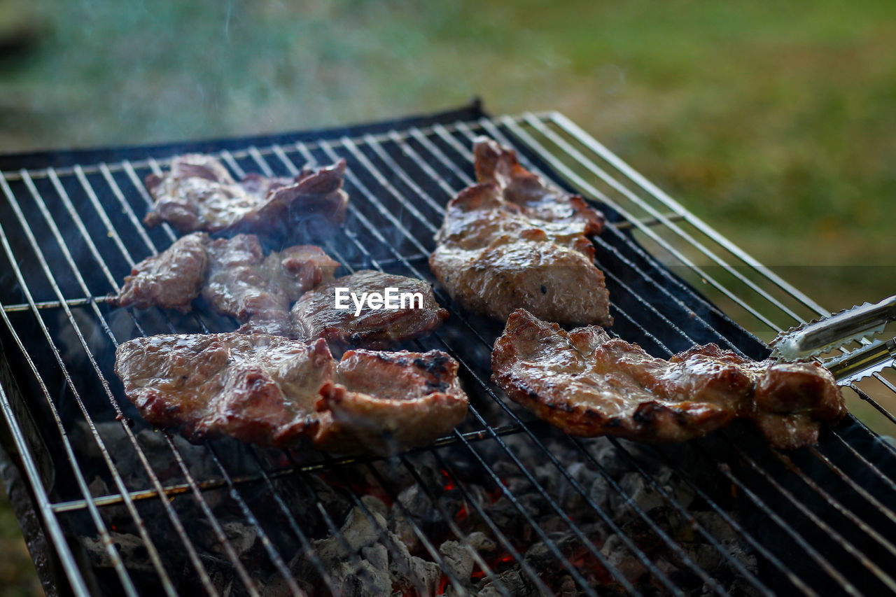 High angle view of meat on barbecue grill