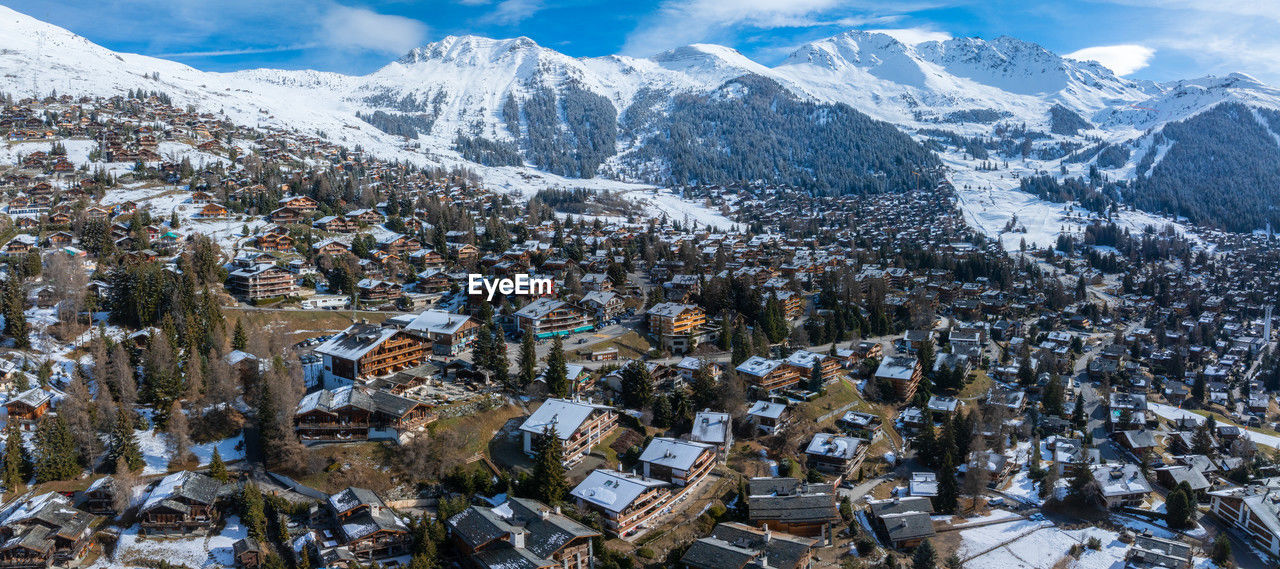 high angle view of townscape and snowcapped mountains