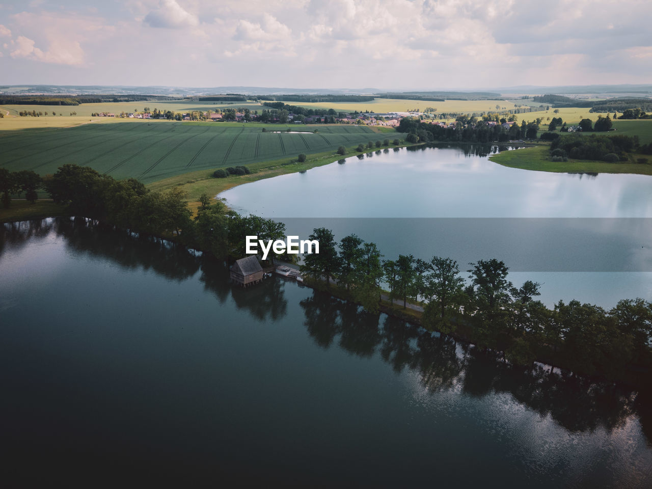 SCENIC VIEW OF LAKE AMIDST TREES AGAINST SKY