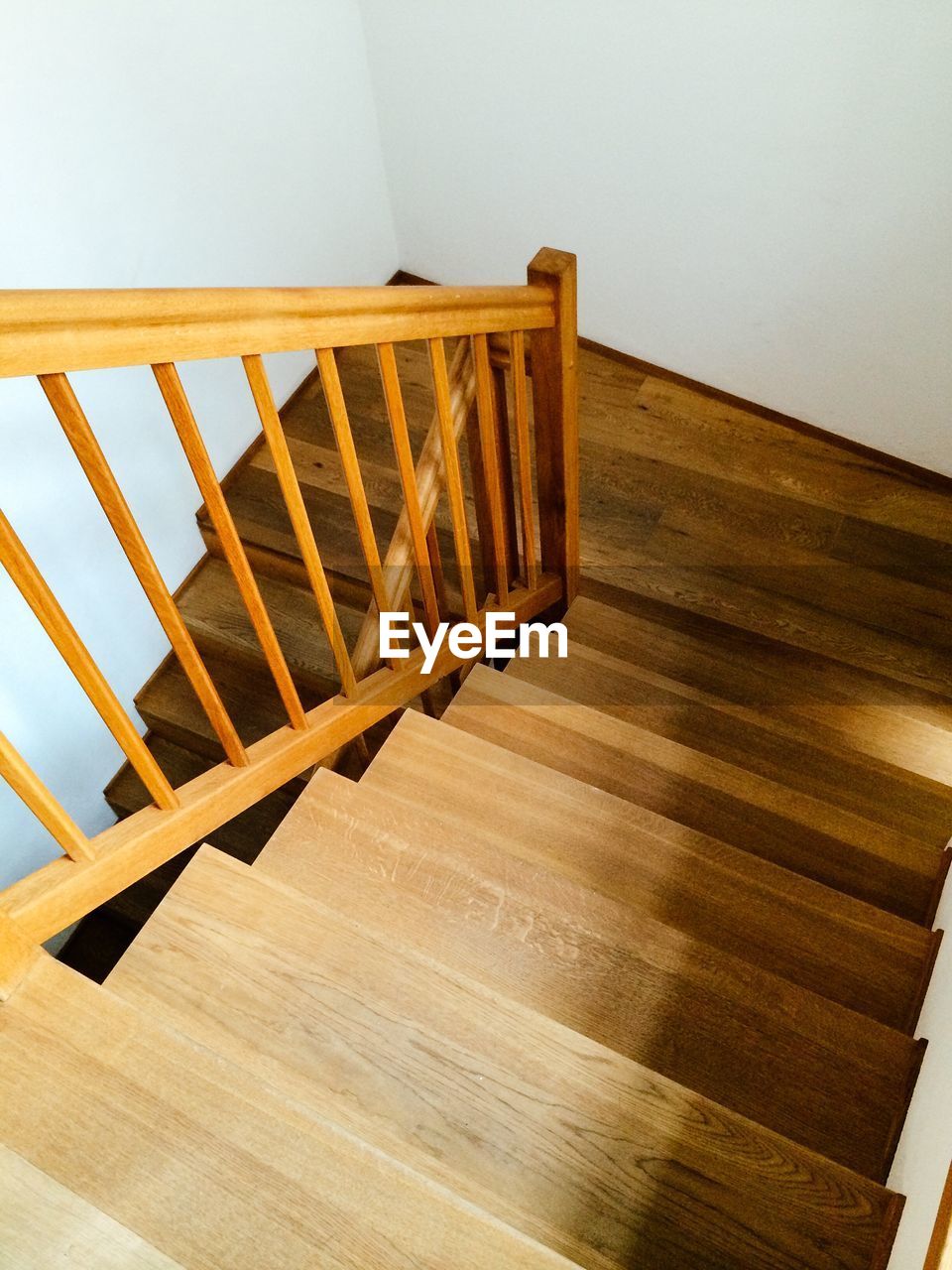 HIGH ANGLE VIEW OF EMPTY CHAIR ON HARDWOOD FLOOR