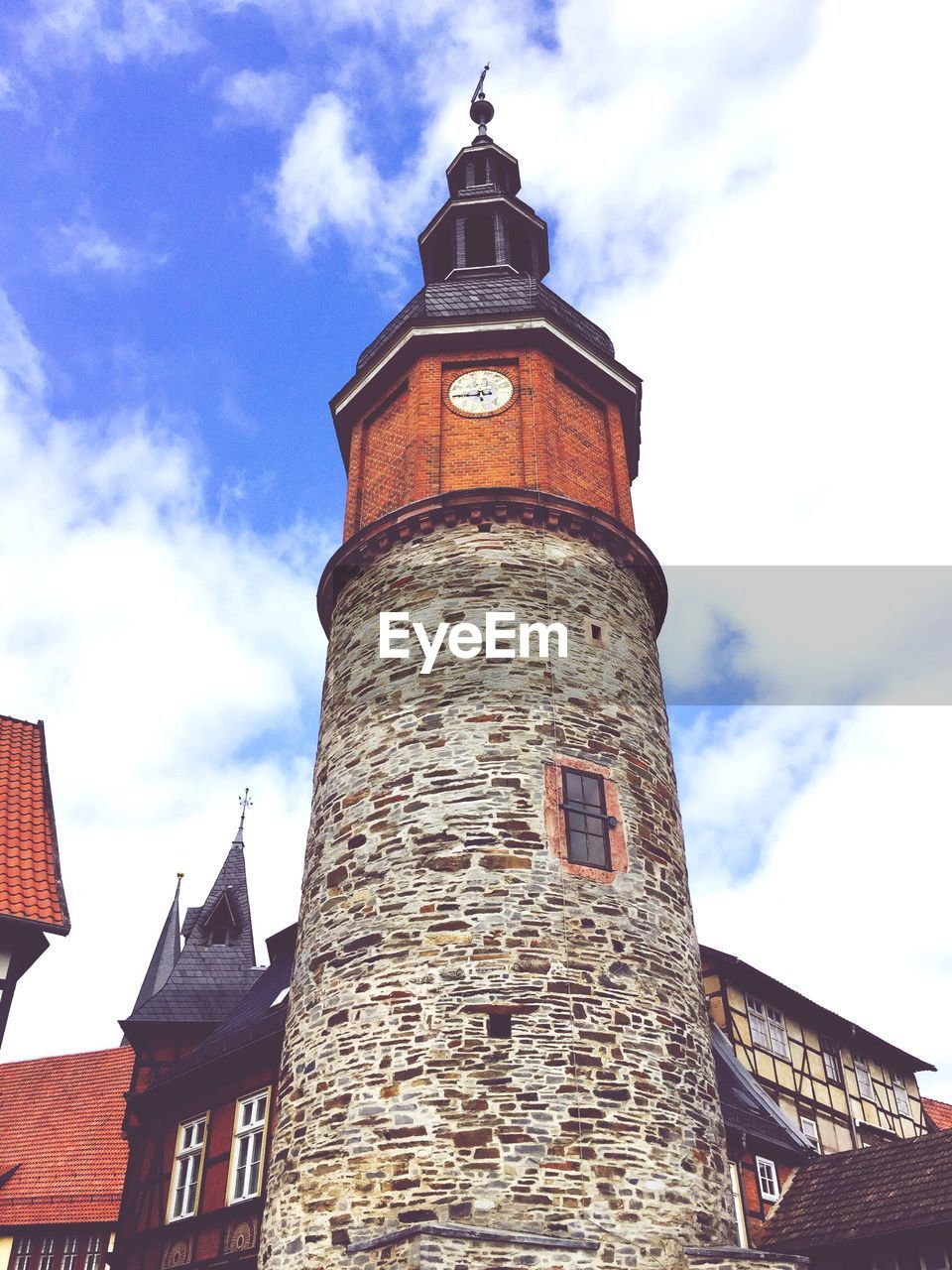 Low angle view of tower against cloudy sky