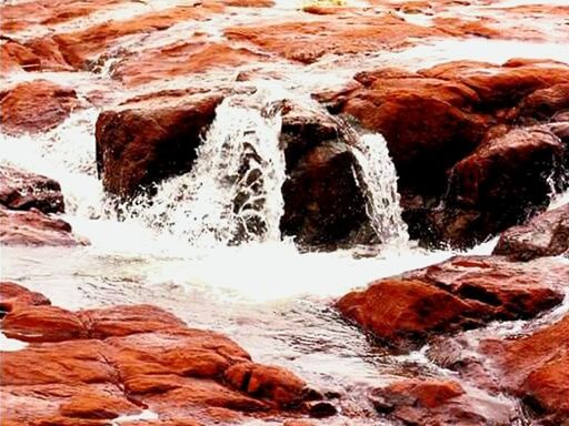 SCENIC VIEW OF WATERFALL AGAINST SKY