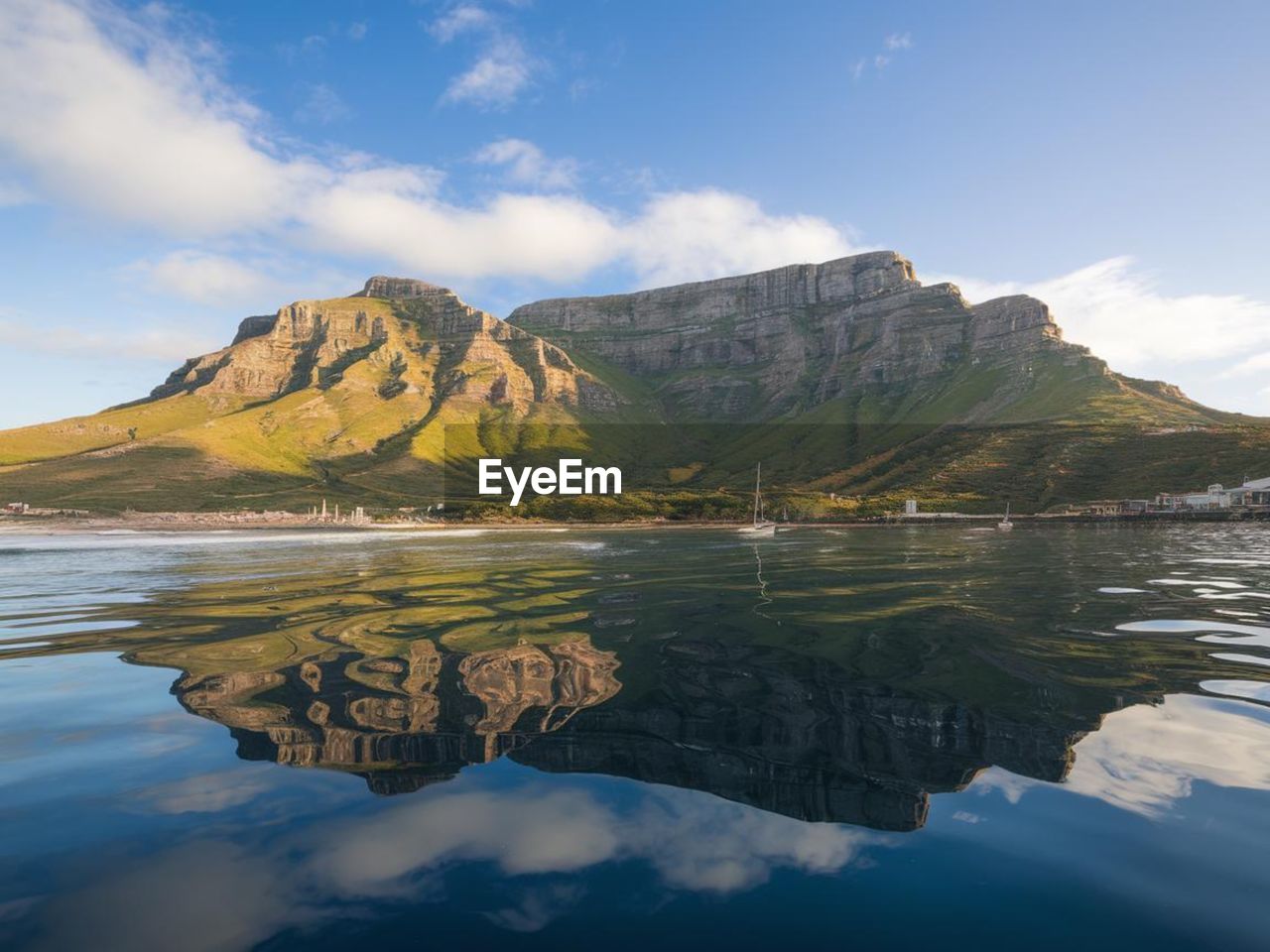 water, mountain, reflection, sky, scenics - nature, lake, landscape, environment, beauty in nature, nature, land, cloud, travel destinations, travel, mountain range, no people, tranquility, blue, body of water, tranquil scene, reservoir, outdoors, wilderness, beach, coast, highland, tourism, rock, day, bay, trip, non-urban scene, mountain peak, vacation, lagoon, holiday